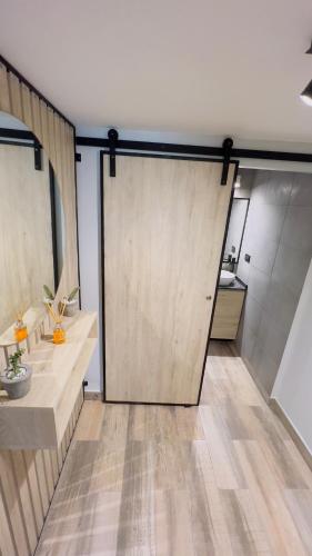 a large sliding door in a room with a kitchen at Park View Studio in San Miguel de Tucumán
