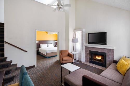 a living room with a couch and a fireplace at Residence Inn San Diego La Jolla in San Diego