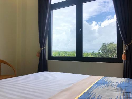 Postel nebo postele na pokoji v ubytování Hoàng Đô Hotel