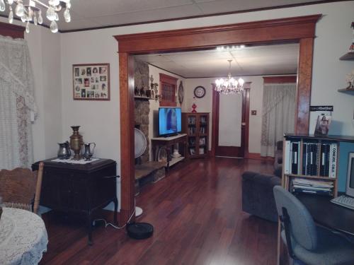 a living room with a couch and a table and a television at Quiet FULL-SIZE bed close to town 420 friendly in Trinidad
