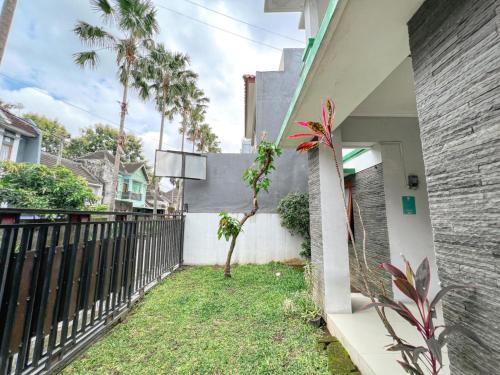 a view from the outside of a house with a fence at Homestay Simply Homy Jogja dekat Ambarukmo plaza in Yogyakarta