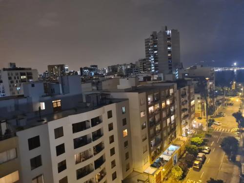 a view of a city at night at Miraflores habitación separada con privacidad dentro de departamento compartido in Lima