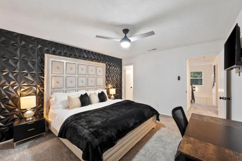 a bedroom with a large bed with a black blanket at Green Resort: 3bd/2.5 bath near AT&T Stadium in Arlington