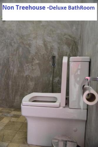 a bathroom with a toilet with the words non hostage bathroom bathroom room at Wilpattu Tree House in Wilpattu