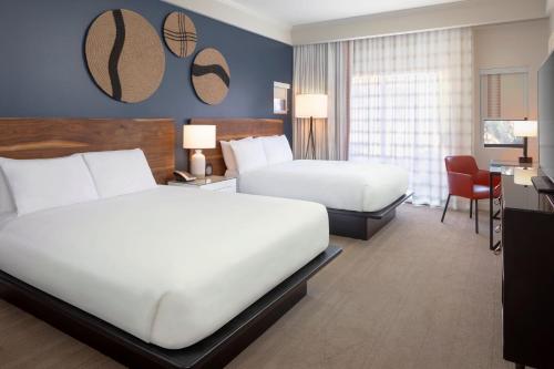 a hotel room with two beds and a desk at Amara Resort & Spa in Sedona