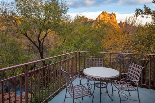 a table and chairs on a balcony with a view at Amara Resort & Spa in Sedona