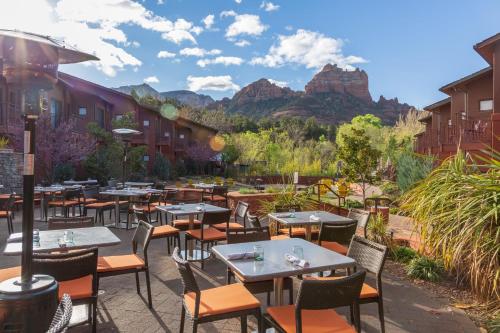 a restaurant with tables and chairs with mountains in the background at Amara Resort & Spa in Sedona
