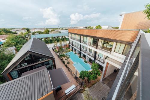 an overhead view of a building with a swimming pool at Phu sakon ville hotel in Ban Phang Khwang Tai