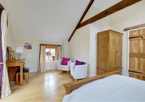 a bedroom with a bed and a chair and a desk at Felin Fach in Pumpsaint