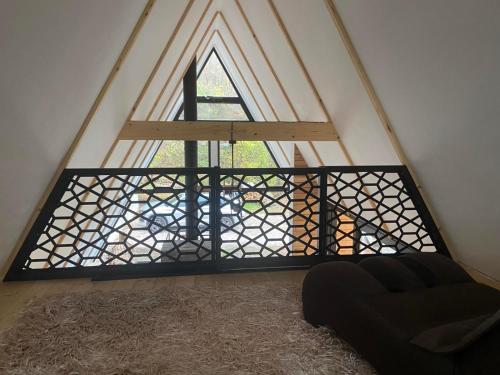 a room with a window with a black iron fence at Crna Ovca Lopatnica in Lopatnica