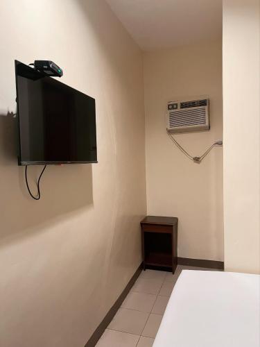 a room with a flat screen tv on a wall at Blue Velvet Hotel -CM Recto in Davao City