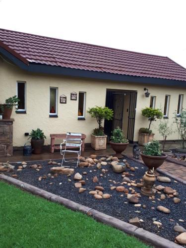 a patio with a chair in front of a house at Forget me Not Lydenburg in Lydenburg