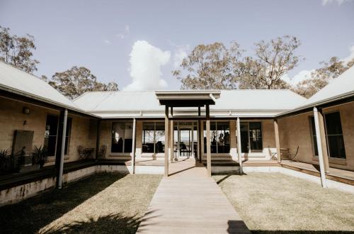 an exterior view of a house with a porch at Huge house Your Hunter Valley Wine Staycation ! in Pokolbin