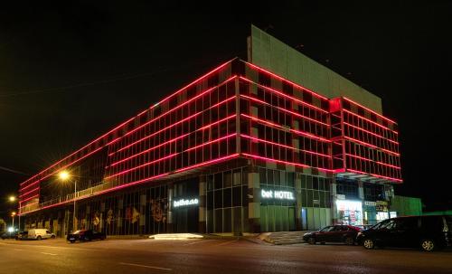a large building with red lights on it at night at BET25 Hotel in Batumi
