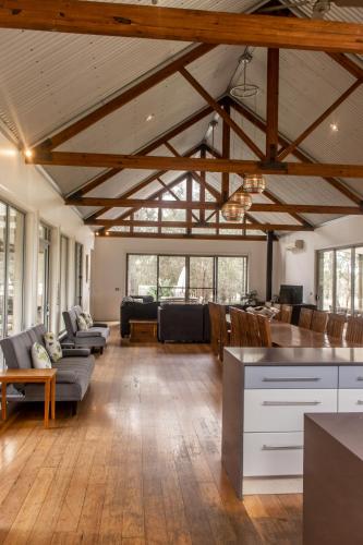 a large living room with wooden ceilings and wooden floors at Huge house Your Hunter Valley Wine Staycation ! in Pokolbin