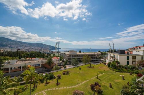 a park in the middle of a city with buildings at Vista Mar I by An Island Apart in Funchal