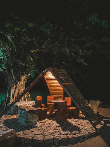 a small wooden structure with a table and chairs at Wilpattu Tree House in Wilpattu