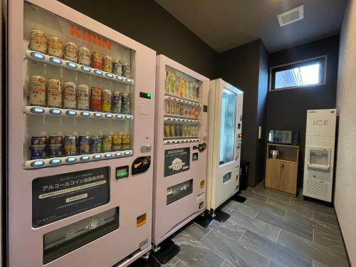 a vending machine in a store with soda at Hotel Route Inn Kyoto Kameoka Ekimae in Kameoka