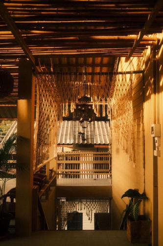 a room with a table and chairs in a building at U're Holitel in Haad Rin