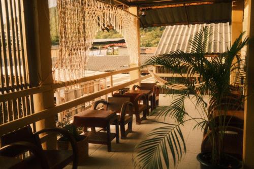 a row of chairs and tables in a building at U're Holitel in Haad Rin