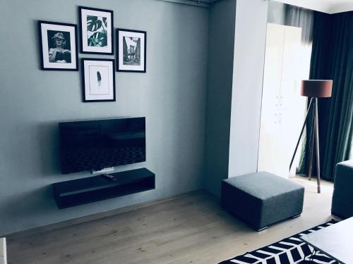 a living room with a flat screen tv on a wall at OTTO LOFT Premium Apartments in Ankara