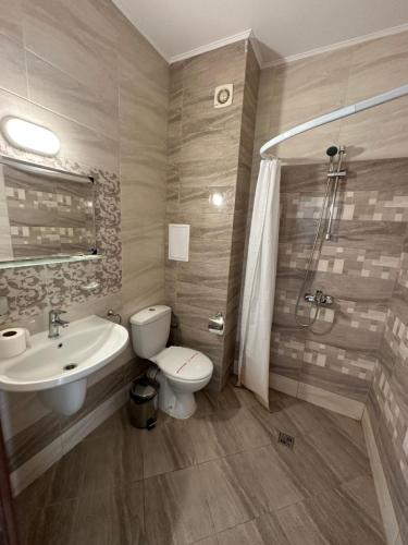 a bathroom with a sink and a toilet and a shower at Вила Quiet Bay in Sozopol