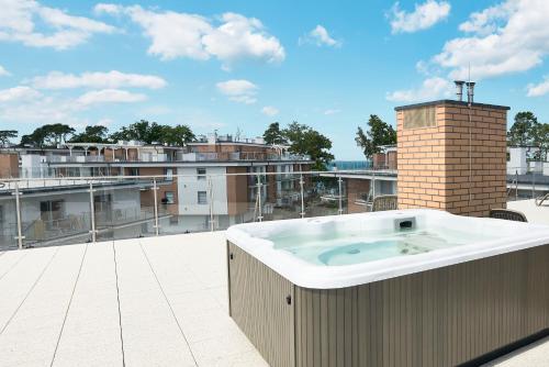 una vasca idromassaggio sul tetto di un edificio di SZAFIROWE APARTAMENTY 3 kryty basen i sauna RESORT KLIFOWA a Rewal