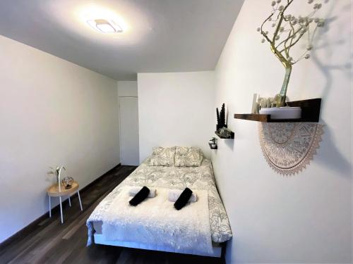 a bedroom with a bed with white walls at Cosy Roissy for Olympic Games in Roissy-en-France