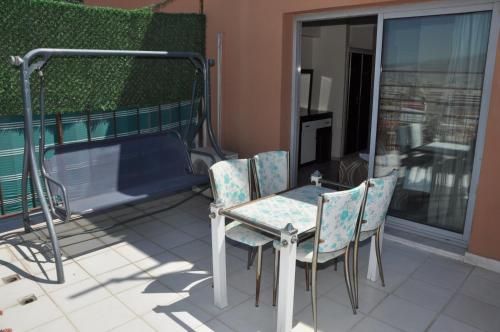 a table and chairs on a balcony with a tub at Konak EuroBest Otel in Konak