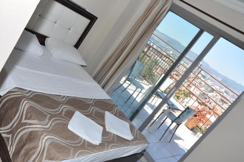 a bedroom with a bed and a large window at Konak EuroBest Otel in Konak