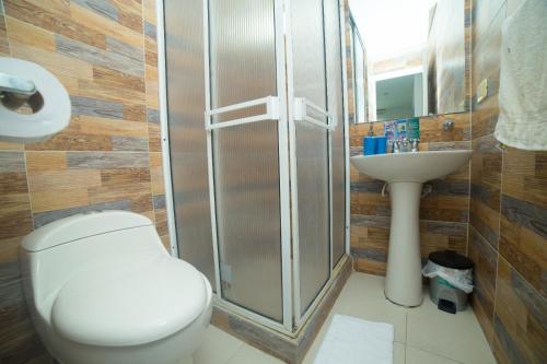a bathroom with a shower and a toilet and a sink at Apartamento 802 Brisas marinas Santa Marta COLOMBIA in Santa Marta