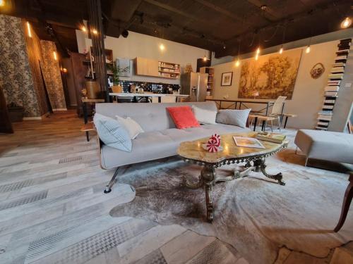 a living room with a couch and a coffee table at O centre in Saint-Avold