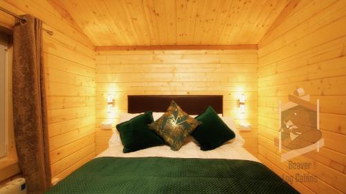 a bedroom with a bed in a wooden room at Glendaloch B&B in Antrim