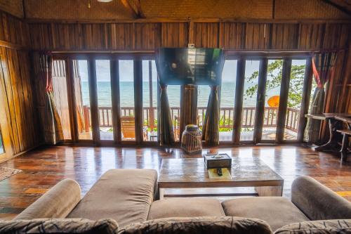 a living room with a couch and a table at Koh Jum Resort in Ko Jum