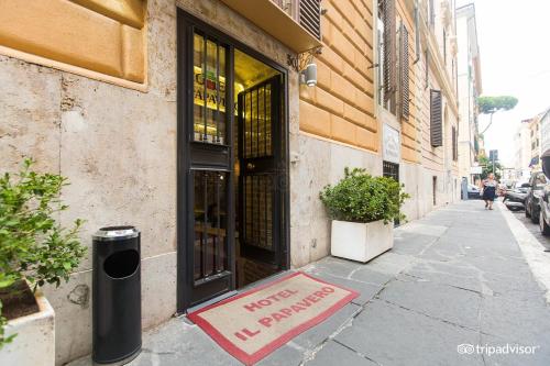 un panneau sur le trottoir devant un bâtiment dans l'établissement Hotel Il Papavero, à Rome