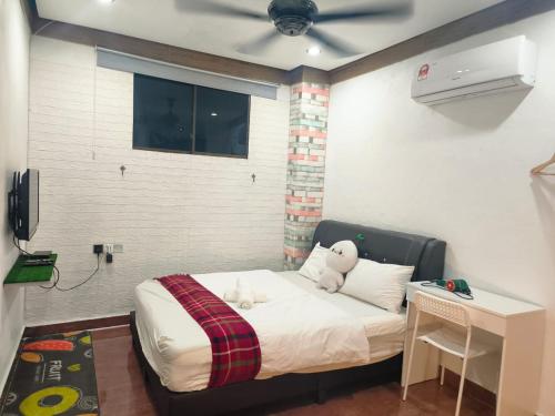 a bedroom with a bed with a stuffed animal on it at Taiping Vacation Home in Taiping