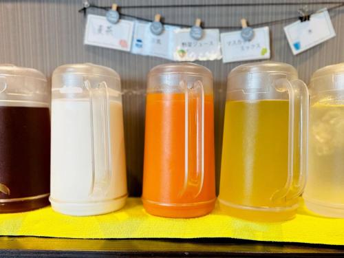 a row of mason jars filled with different colored liquids at Hotel Green Arbor in Sendai