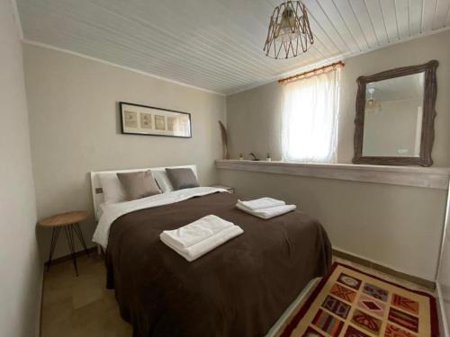 a bedroom with a bed with two towels on it at Casa Di Datca in Datca