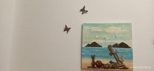 a painting of birds flying over the beach at allafontanina in Minori