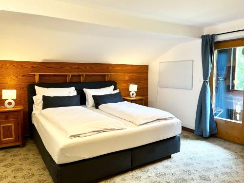 a bedroom with a large bed with a wooden headboard at Ferienhaus Anni in Kreuth