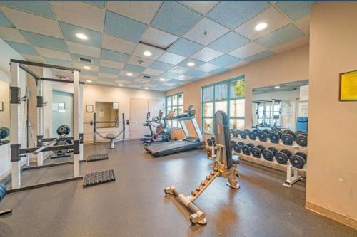 a gym with several treadmills and machines at Stunning ocean (sound of waves) in Vancouver