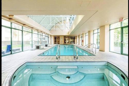 a large swimming pool in a large building at Stunning ocean (sound of waves) in Vancouver