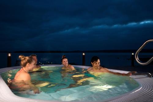 a group of people in a hot tub at night at Break Sokos Hotel Bomba in Nurmes