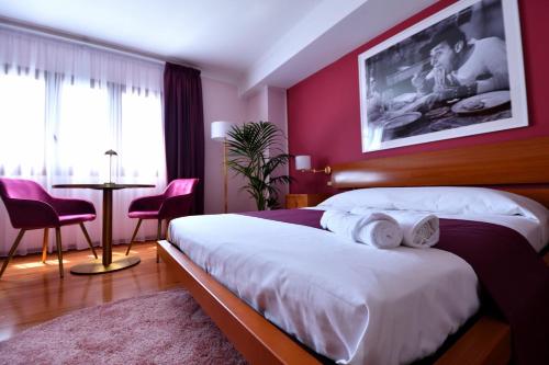 a bedroom with a large bed with red walls at Le Cinéma in Formia