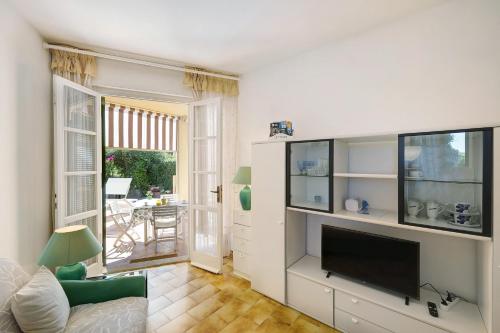 a living room with a flat screen tv and a couch at Isabel Beach and Bike in Finale Ligure