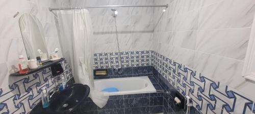 a bathroom with a sink and a toilet in it at Cozy 3BR Place Nasr City in Cairo