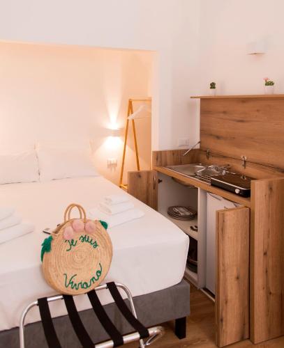 a room with a bed with a bag on it at ALMAMI Loft & Rooms in Monopoli