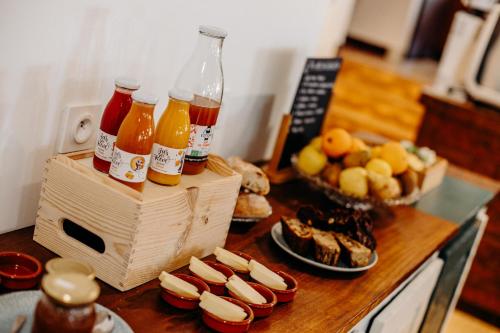 a table with a bunch of bottles of drinks and food at Logis Hôtel Restaurant Espelletenia in Larceveau-Arros-Cibits