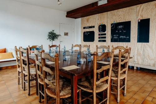 a dining room with a wooden table and chairs at Logis Hôtel Restaurant Espelletenia in Larceveau-Arros-Cibits