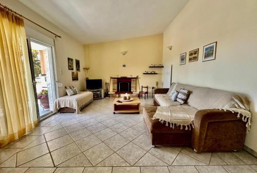 ein Wohnzimmer mit einem Sofa und einem Kamin in der Unterkunft Shell-paralia ofriniou in Ofrynio